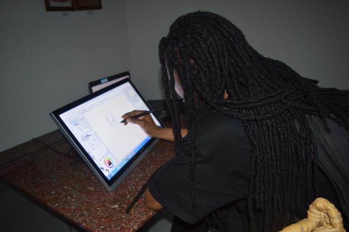 Seif Bizimana, one of the illustrators of Kinyarwanda children's books demonstrating a live illustration session during the website launch