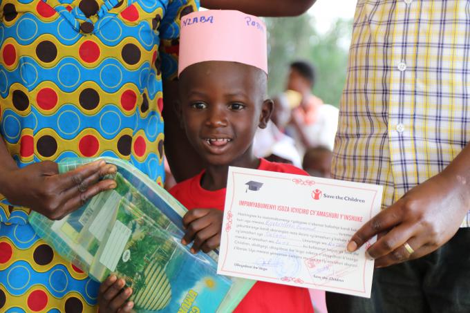 Mucyo recieved his certificate and is happy to be promoted to primary from pre-primary