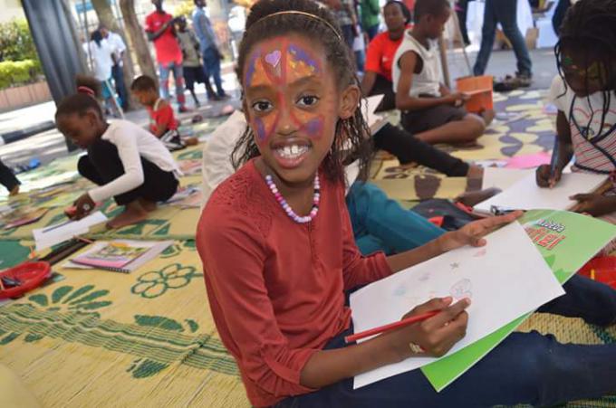 One of the children happily participating in the activities of the Chocolate Book Campaign